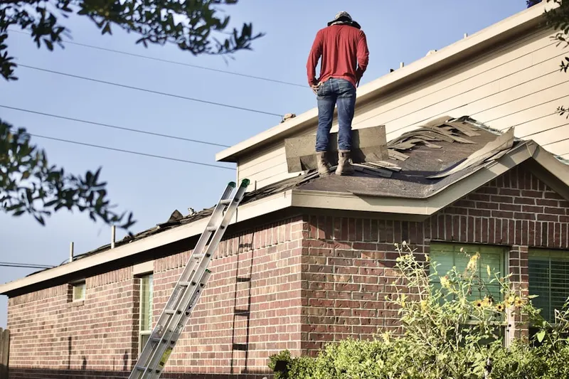 Professional roofer working on a residential roof in Crystal